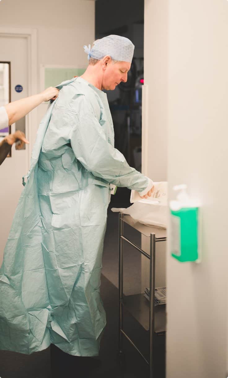 Ophthalmology surgeon Andrew Luff (Andy Luff), in full surgical attire preparing for cataract surgery